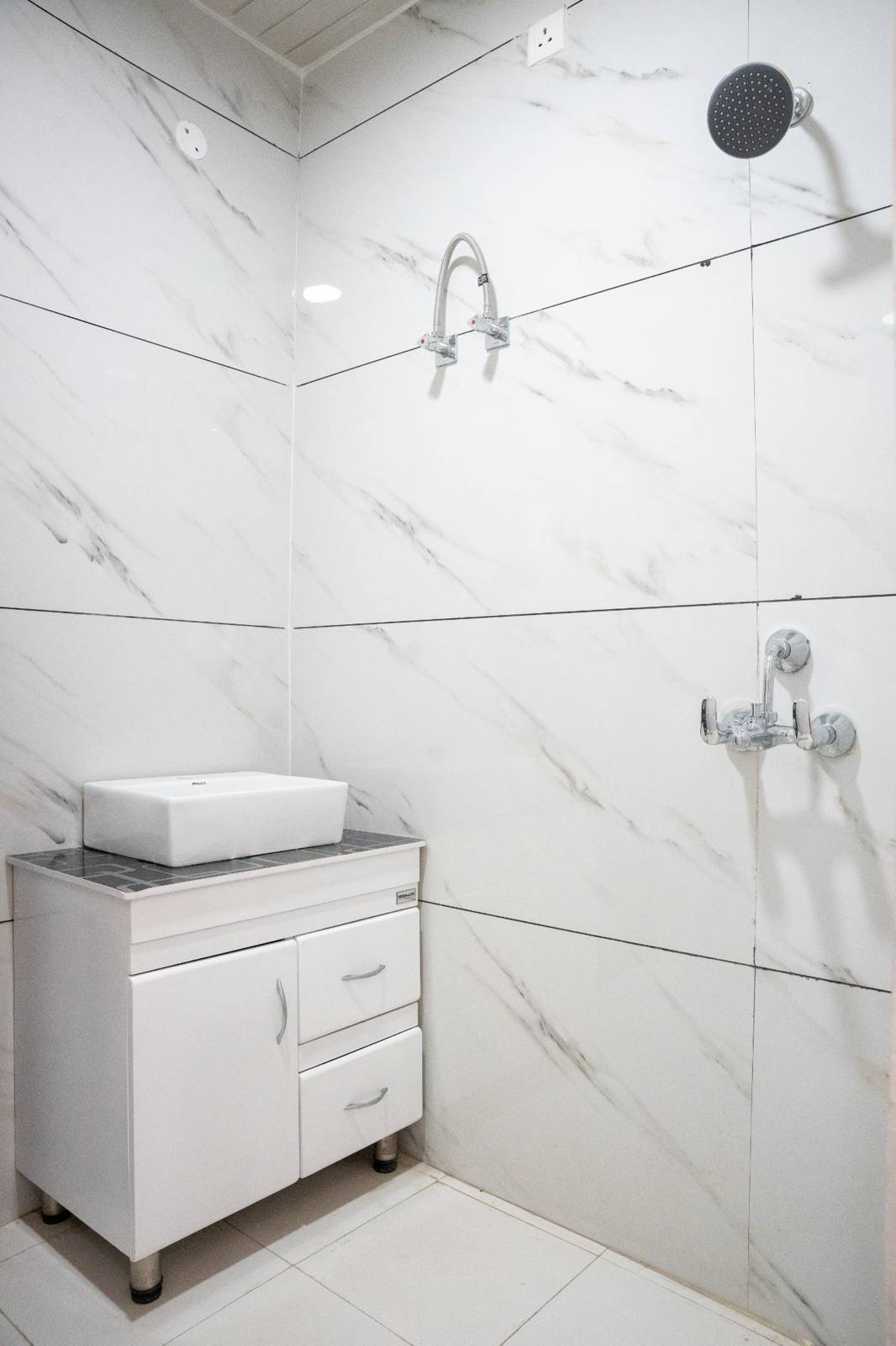 2 BHK bathroom vanity and shower area