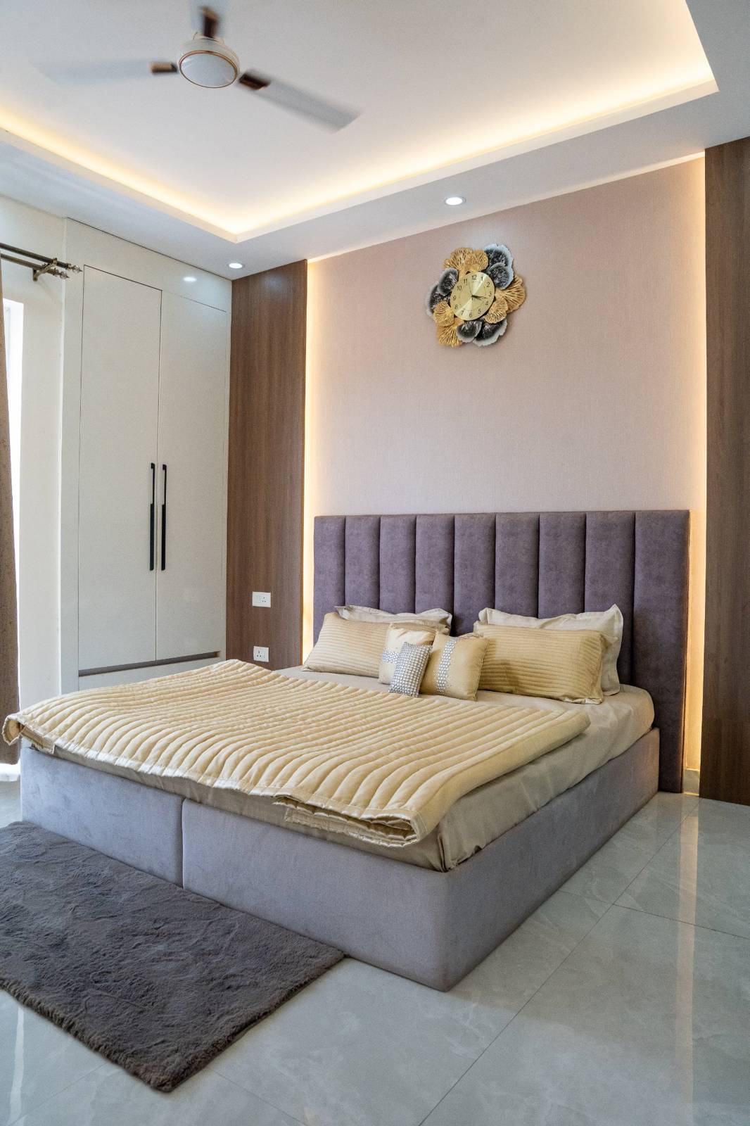 2 BHK bedroom with warm ceiling lighting